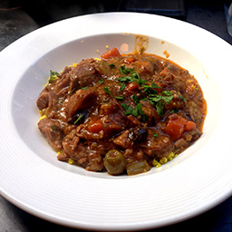 Slow-cooked beef stew with olives and cous cous